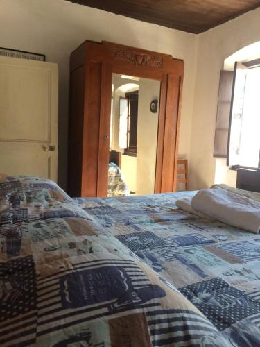 a bedroom with a bed with a quilt on it at Medieval Village B&B in Ne