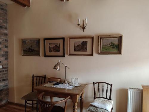a dining room with a table and chairs and a lamp at U Anny Šmejdířky in Nymburk