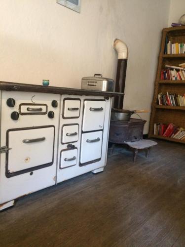 a kitchen with an old stove and a stove at Medieval Village B&B in Ne