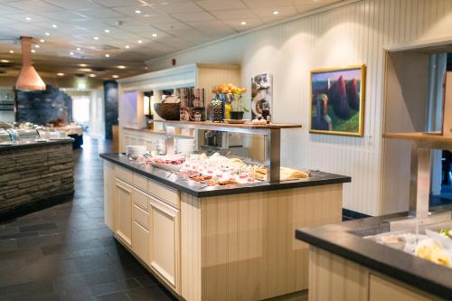 a buffet line in a restaurant with food at Røros Hotell - Bad & Velvære in Røros