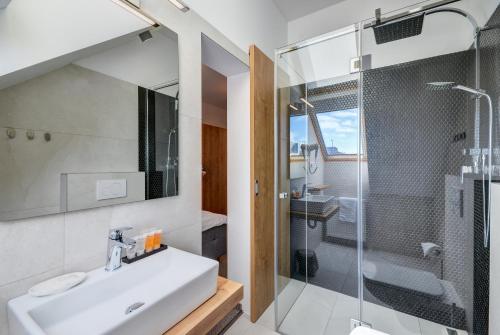 a bathroom with a sink and a shower at Penzión Elements in Trnava