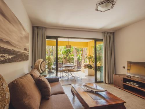 a living room filled with furniture and a window at Atlantic Garden Beach Mate in Corralejo