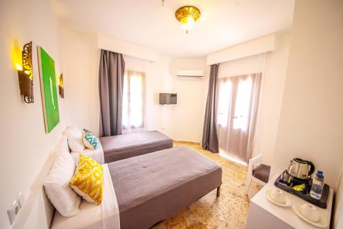 a small room with a bed and a couch at Murat Pasha Mansion in Dalyan