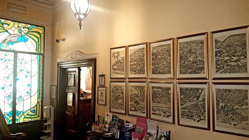 a room with a bunch of drawings on the wall at Soggiorno Angelus in Rome