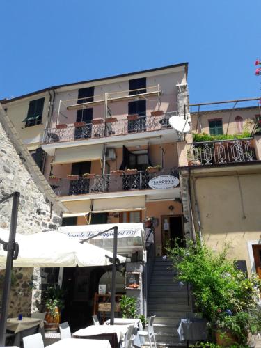 a building with a staircase leading up to a restaurant at affittacamere la loggia in Levanto