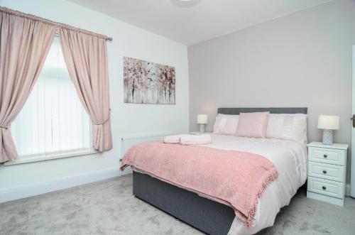 a white bedroom with a large bed and a window at RIVERPOOL - LUXRY SUITS FOR FOOTBALL FANS NEAR AnFIELD STADIUM in Liverpool