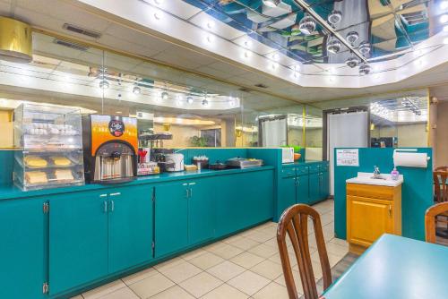 a large kitchen with blue cabinets in a restaurant at Econo Lodge & Suites Clarksville in Clarksville
