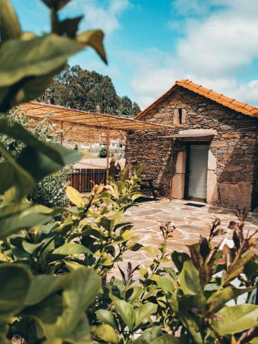 a stone building with a gate in front of it at Casa da Eira in Arouca