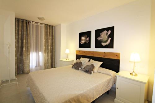 a bedroom with a bed with two pillows on it at Altos de Nuevo Vera in Vera