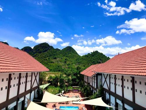a view of a resort with mountains in the background at Victory Road Villas in Phong Nha