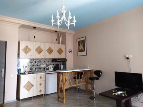 a kitchen with a table and a stove top oven at Hostel Retro in Batumi