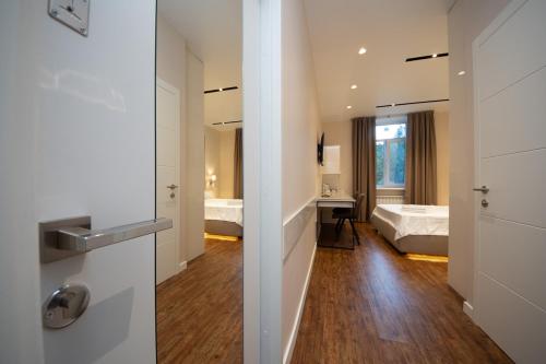 a room with a bathroom with a bed and a sink at Современный минимализм в центре Киева. in Kyiv