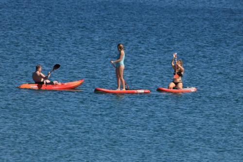 a group of people on surfboards in the water at Strandways Court Apartment in Saundersfoot