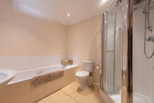 a bathroom with a toilet and a sink and a shower at The Oaks - Ash Farm Cotswolds in Stow on the Wold