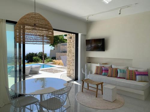 a living room with a table and a couch at Mimi and Coco Villas Corfu in Paramonas