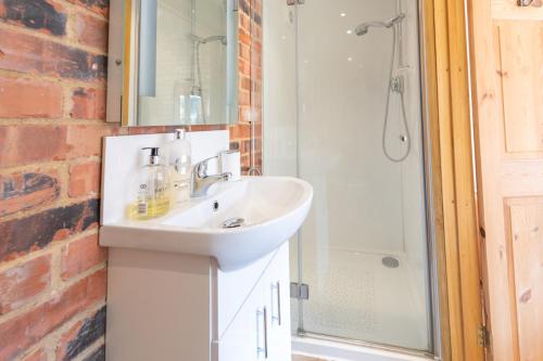 a bathroom with a sink and a shower at Mill Cottage 2 - Ash Farm Cotswolds in Stow on the Wold