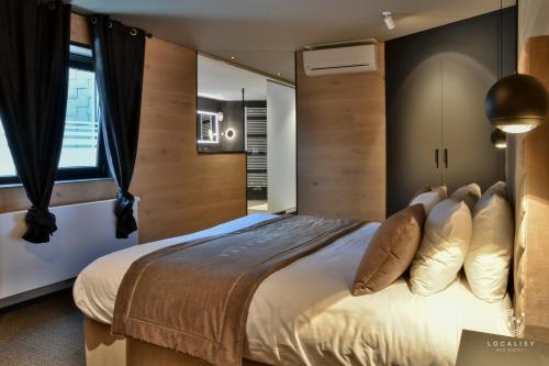 a bedroom with a large bed and a window at Domaine Des Hautes Fagnes in Ovifat