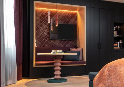 チューリッヒにあるSorell Hotel St. Peterのダイニングルーム(テーブル、テレビ付)