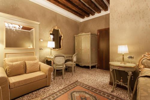 a living room with a couch and a table at Hotel Al Ponte Mocenigo in Venice