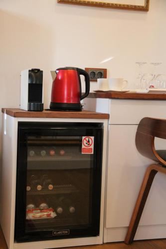 a red tea kettle sitting on top of an oven at Oblivion Luxury Rooms in Split