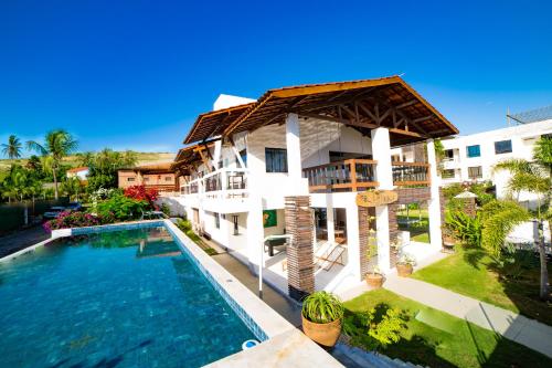 an aerial view of a house with a swimming pool at Inn Tribus Hotel in Flecheiras