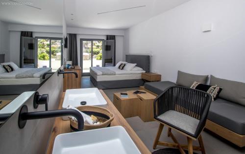a living room with a couch and a table at Oro Suites in Kinion