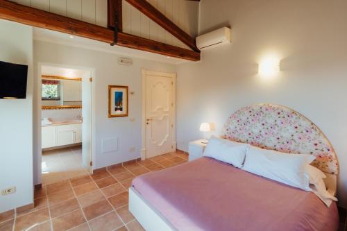 a bedroom with a large bed and a bathroom at Alle Pendici del Conero in Sirolo