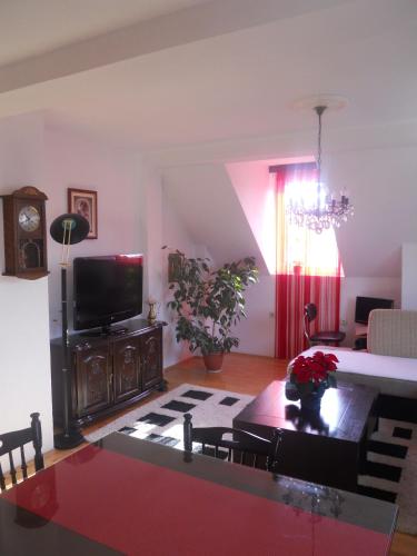 a living room with a tv and a table at Nikolic Apartments - Ohrid City Centre in Ohrid
