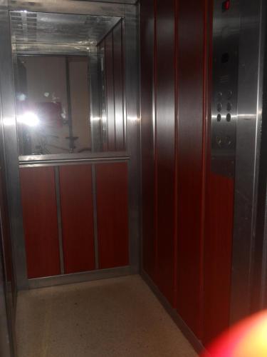 a person taking a picture of a mirror in a elevator at Nikolic Apartments - Ohrid City Centre in Ohrid