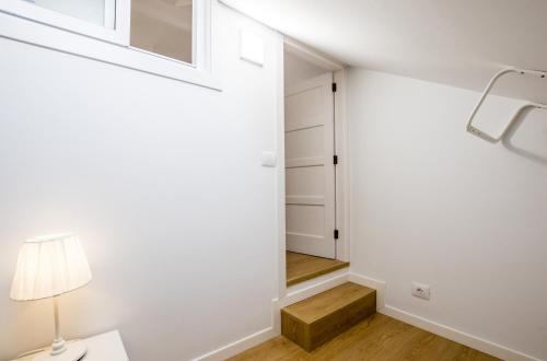 a hallway with a door leading into a closet with a lamp at Parque Santiago 1 Duplex 2A014 in Playa de las Americas