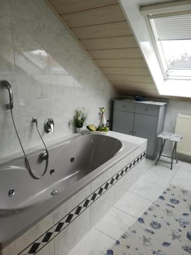 a large bathroom with a large tub in a room at Ferienwohnung Rabelsdorf in Pfarrweisach