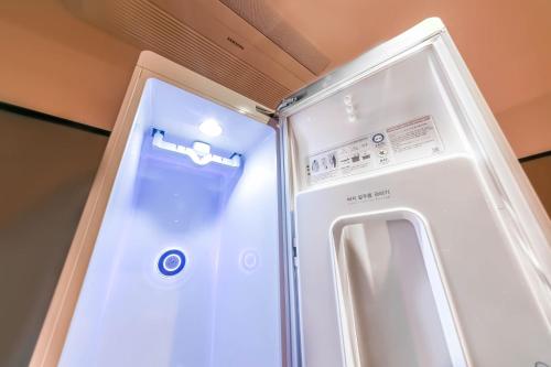 a refrigerator with its door open in a room at Pohang Brown Dot Hotel in Pohang