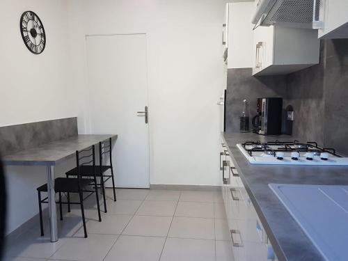 a kitchen with a counter and a stove top oven at GITE DE LA GARÈNE in Grillon
