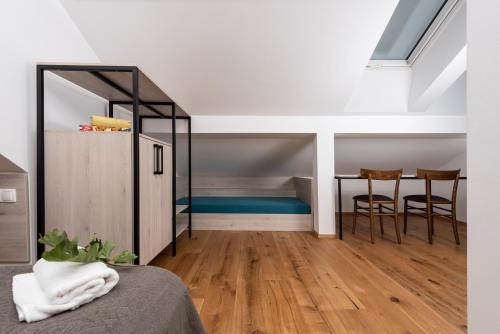 a room with a bed and a table and chairs at Fani&Rozi B&B in Maribor