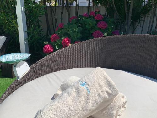 a towel sitting on top of a table with flowers at White House Luxury Hospitality in Olbia