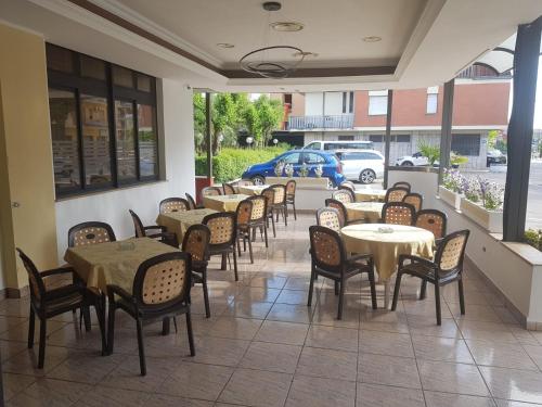 a row of tables and chairs in a restaurant at Hotel Residence Memmina in Frosinone