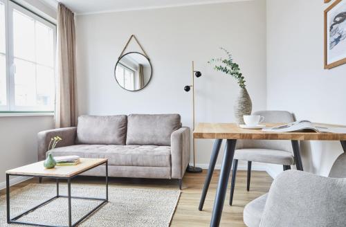 a living room with a couch and a table at Villa Fortuna in Ostseebad Sellin