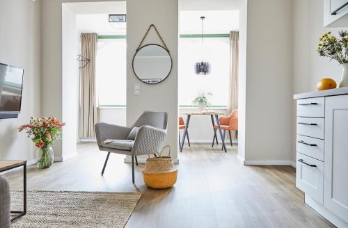 a living room with a chair and a mirror at Villa Fortuna in Ostseebad Sellin