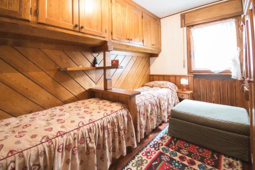 um quarto com 2 camas e uma janela em Casa vacanze 5 Torri em Cortina dʼAmpezzo