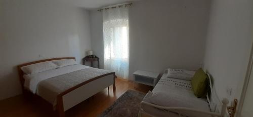 a bedroom with two beds and a window at Apartments Villa Sandi in Izola