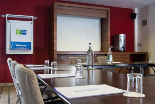 a dining room with tables and chairs and a window at Holiday Inn Express Leeds City Centre by IHG in Leeds