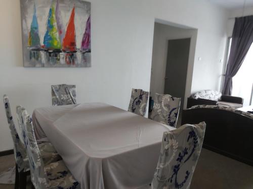a dining room with a white table and chairs at FH Comfy Home in Bukit Fraser