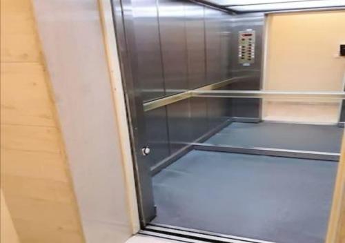 an empty elevator with a glass door in a room at House in the center of Piraeus next to the port and the metro!! in Piraeus