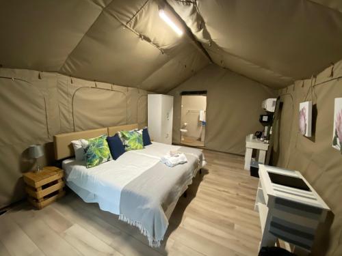 a bedroom with a bed in a tent at Lions Rock Rapids - Luxury Tented Camp in Hazyview