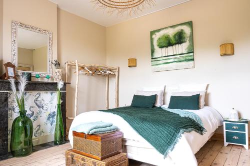 a bedroom with a bed and a mirror at Le Jardin Des Secrets "Gites et chambres à louer" in Namur