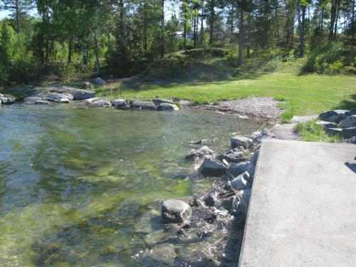 a river with some rocks in the water at Stenslid Bottna By St Anna in Söderköping