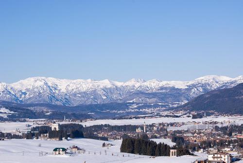 a view of a town in the snow with mountains at Chalet Orchidea in Gallio