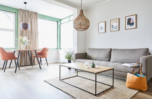 a living room with a couch and a table at Villa Fortuna in Ostseebad Sellin