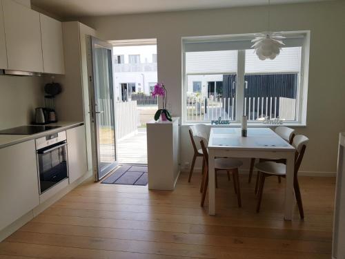 a kitchen and dining room with a table and chairs at Ana's Bed & Kitchen in Copenhagen
