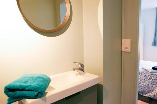 une salle de bain avec un lavabo et un miroir dans l'établissement Vue dégagée Pyrénées Pau - 3 chambres 6 pers- Parking Gratuit, à Pau